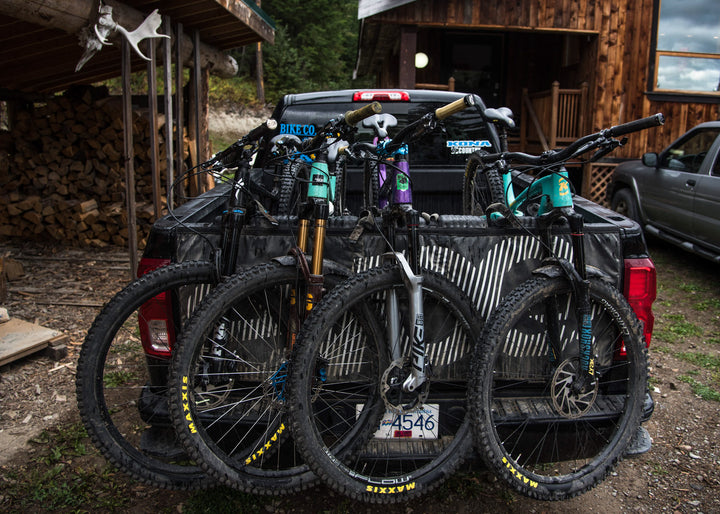 Truck with mountain bikes in tray on an Evoc truck pad