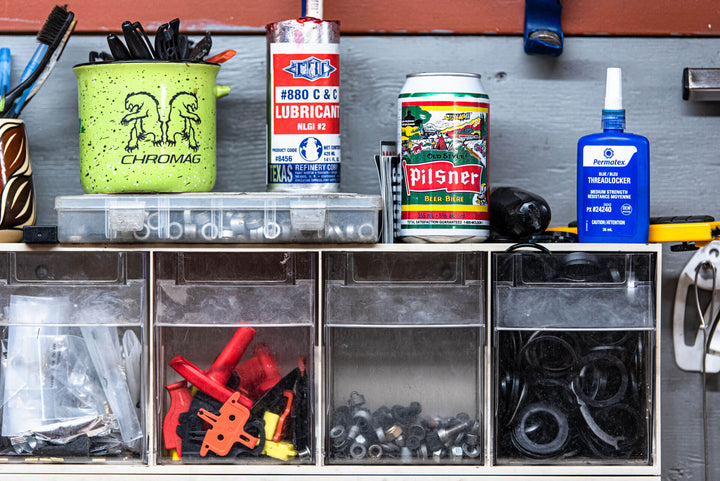Chromag Bikes mug, bike lubricant, Pilsners Beer, thread locker and tools for bike maintenance.